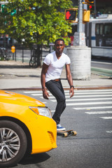 Black Boy Skating with Longboard on the Road