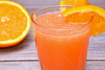 Fresh orange juice on wooden table