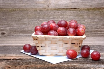 Grapes in basket on wooden background
