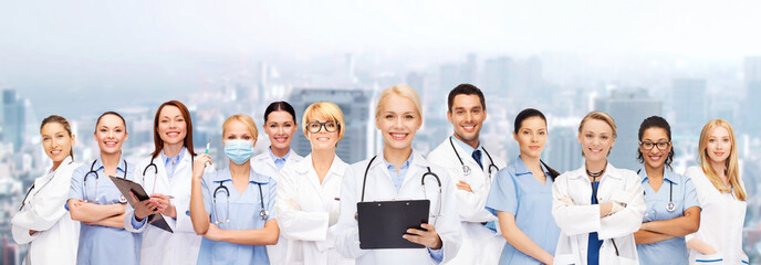 smiling female doctors and nurses with stethoscope