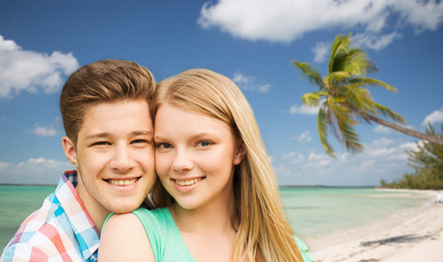Fototapeta na wymiar smiling couple hugging over beach background