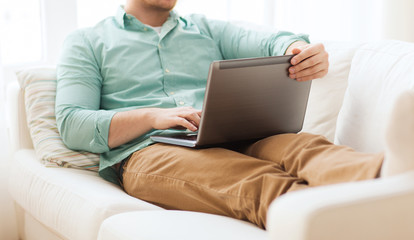 close up of man working with laptop at home