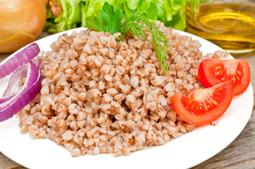 buckwheat groats in a bowl on a wooden table