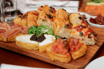 Italian appetizers on wooden plank
