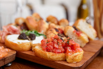 Italian appetizers on wooden plank