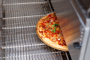 Pizza being baked in industrial oven