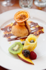 Ice-cream dessert with fruits in plate
