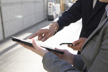 Men pointing the electronic tablet