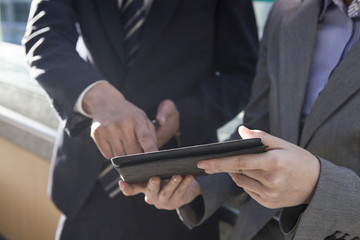 People who are pointing the electronic tablet