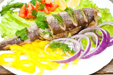 fish hake baked with vegetables on a plate