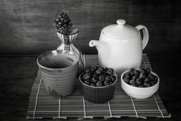 Still life with a cup of fruit on black and white