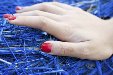 Woman's hand red nail polish.