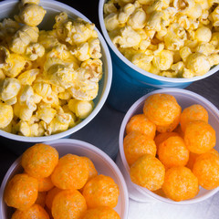 Popcorn and cheesepuffs in plastic cups
