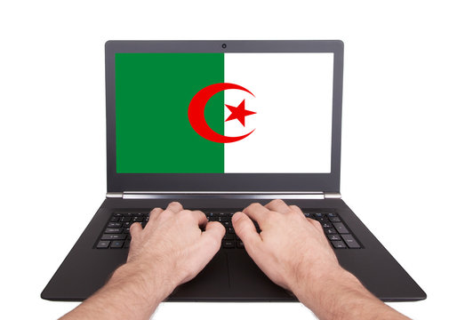 Hands working on laptop, Algeria
