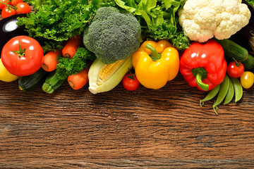 Vegetables and fruits on old wooden background