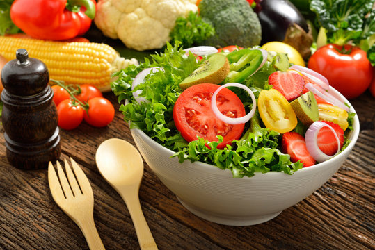 Fruit and vegetable salad in a bowl on wooden table