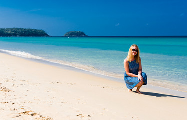 Fototapeta na wymiar Young female enjoying sunny day on tropical beach
