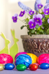 Fototapeta na wymiar Colorful Easter Eggs bunnies pansies