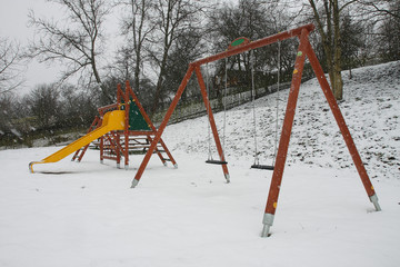 Colorful Playground in a park during snowstorm
