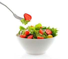 Fruit and vegetable salad in a bowl isolated on white