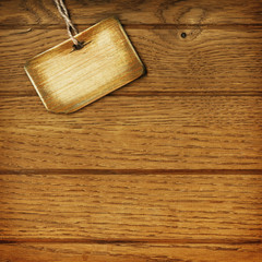 Fototapeta premium Old tag on wooden background