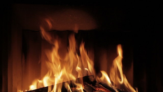 Beautiful real big fire in dark fireplace. Seamless
