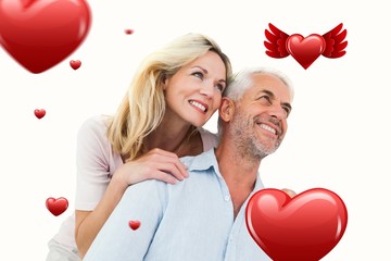 Composite image of smiling couple embracing and looking