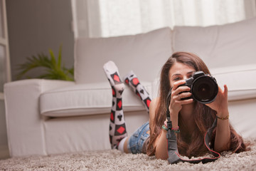 beautiful girl taking photographs at home