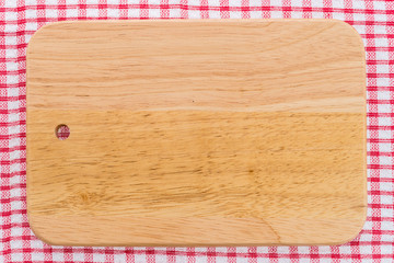 wood cutting board on tablecloth