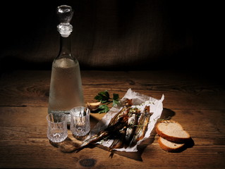 Two glass for vodka with dried capelin and bread