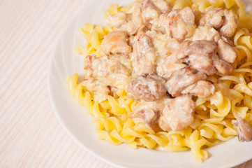 Sliced fried chicken in a creamy sauce. with fusilli pasta