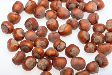 Pile of hazelnuts isolated on white background