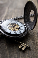 pocket watch over grunge wooden table