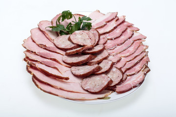 Plate of smoked meat isolated on white background