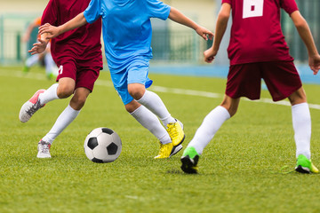 Fototapeta na wymiar Football match for children. Training and soccer game tournament