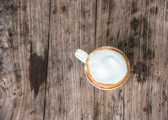 latte coffee cup on the old wood table in top view