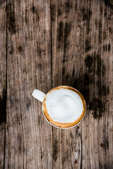 latte coffee cup on the old wood table in top view