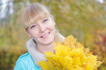 Blonde girl with yellow maple leaf