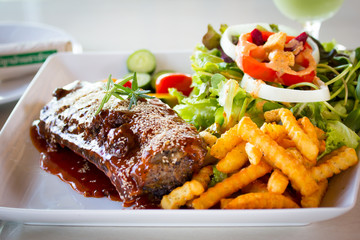 BBQ Ribs - Marinated pork ribs with salad, french fries and barb