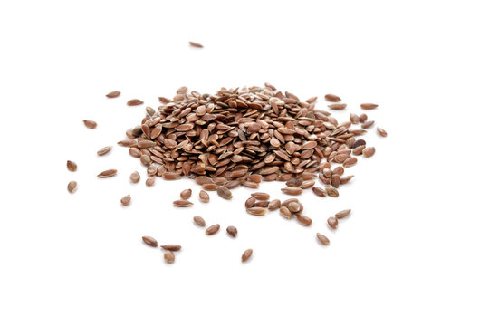 Pile of flaxseeds isolated on white background.