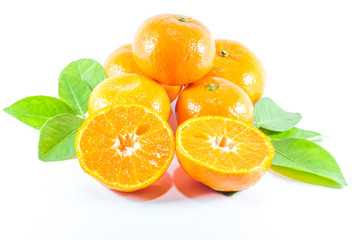 orange cut in half and three whole oranges.