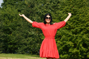 Happy young woman in red dress