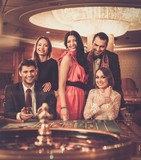 Group of stylish people playing in a casino