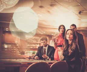 Group of stylish people playing in a casino