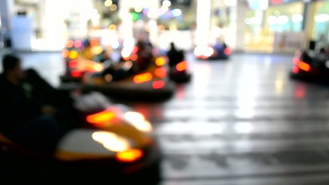 Blurred motion of people driving bumper cars