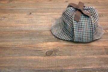 Deerstalker or Sherlock Hat on Wooden Table
