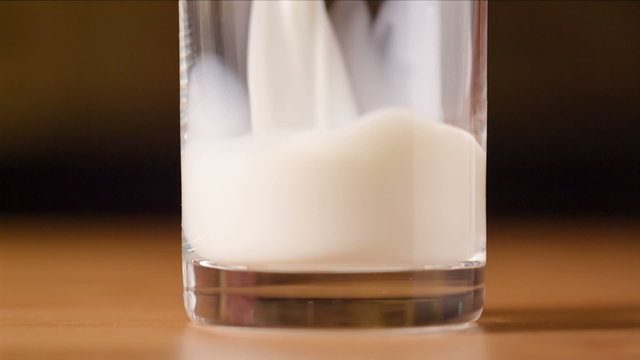 closeup video of pouring milk in glass, full hd footage