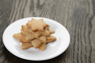 homemade star shape ginger cookies on wood table