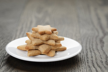homemade star shape ginger cookies on wood table