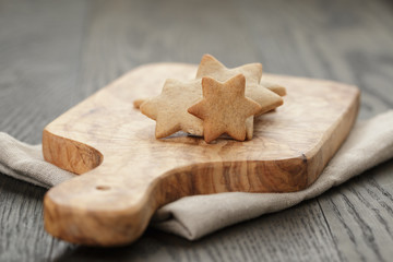 homemade star shape ginger cookies on olive board